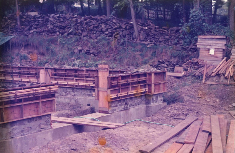 Stone stockpile on the hillside with figures for scale
